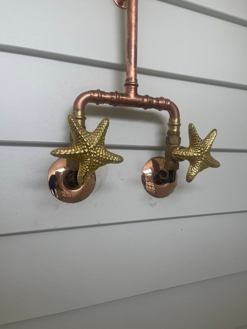 Load image into Gallery viewer, Two starfish covers installed on copper shower
