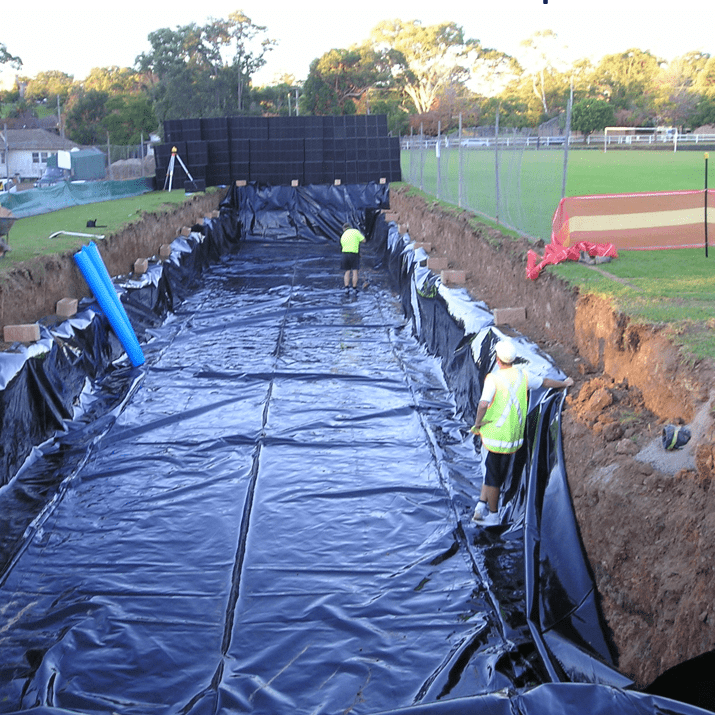 Load image into Gallery viewer, Plastic liner laid down for detention tank
