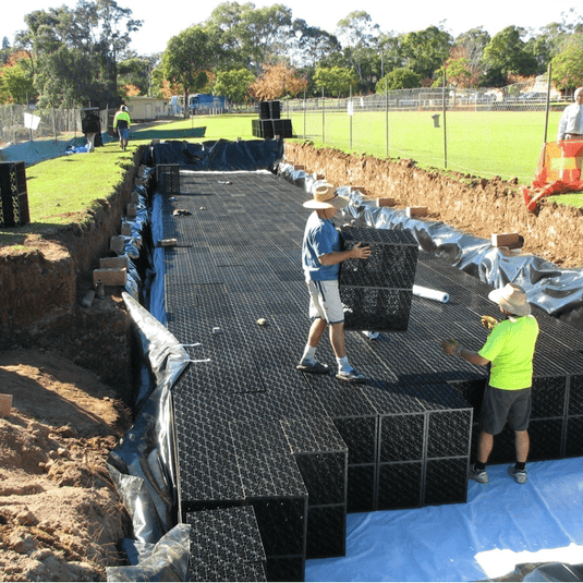 Flo tank modules being placed into excavated pit