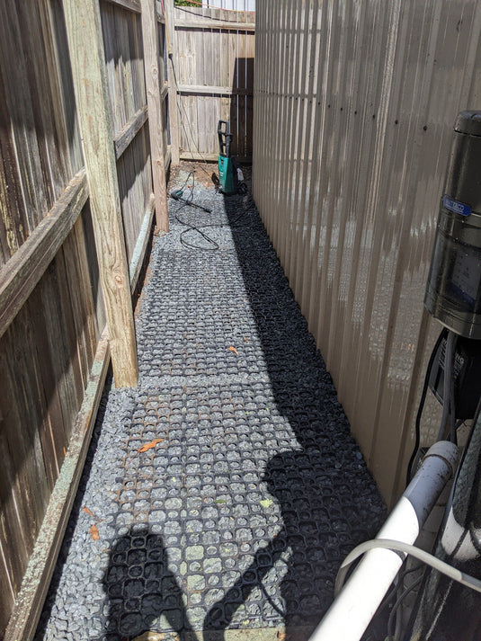 Gravel cell path down side of house